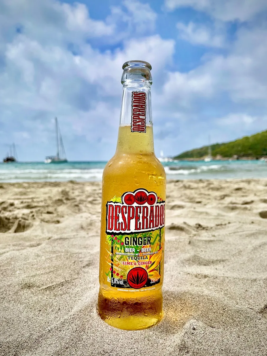 a bottle of beer on a beach